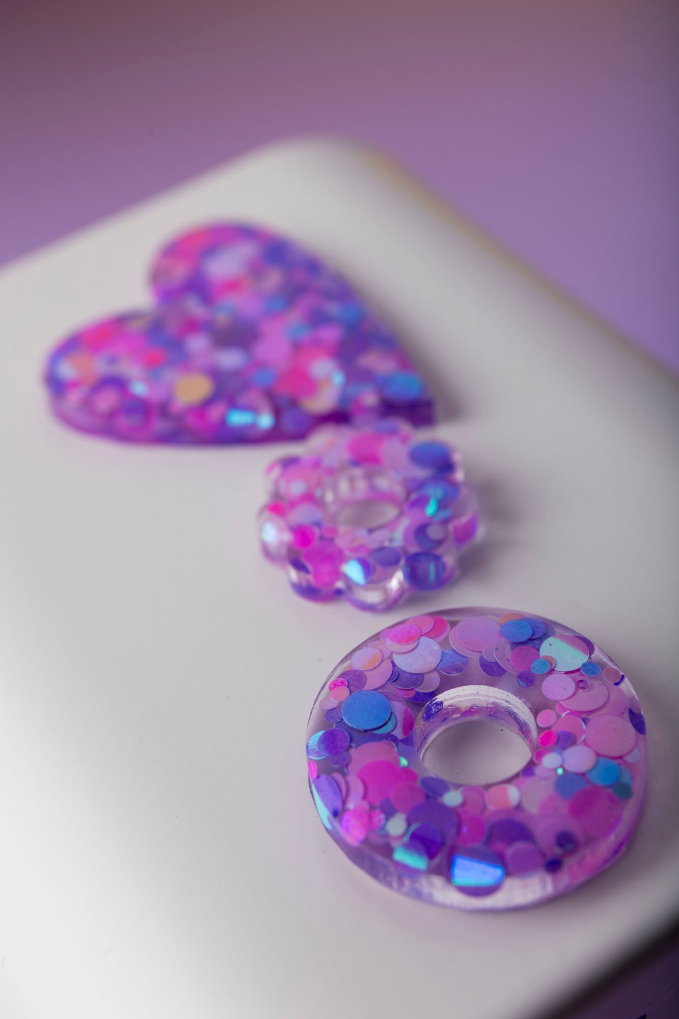 Pampilles en forme de donut fabriquées à la main avec de la résine époxy.